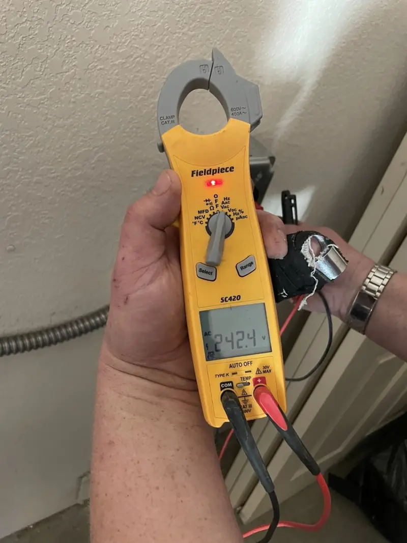 Voltage testing with clamp meter during Ceiling Fan Installation in Casper